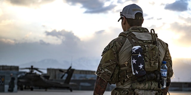 A U.S. Air Force pararescueman, assigned to the 83rd Expeditionary Rescue Squadron, surveys the flightline at Bagram Airfield, Afghanistan, March 22, 2018.