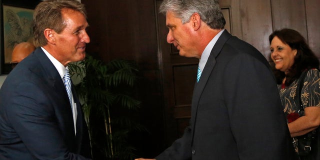 Sen. Jeff Flake, R-Ariz, shakes hands with Cuba's First Vice President Miguel Diaz Canel, at Revolution Palace, in Havana, Cuba, Saturday, June 13, 2015. (AP Photo/Desmond Boylan, Pool)