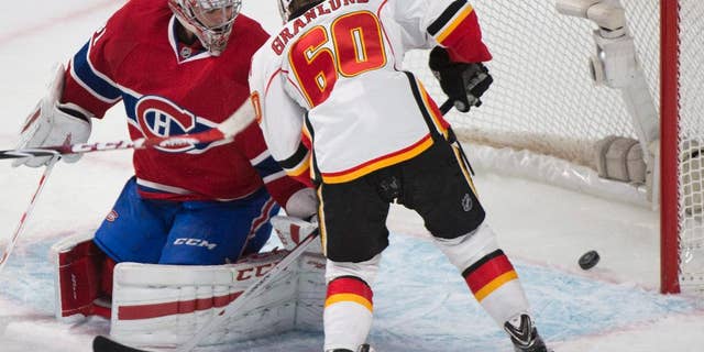 Montreal Canadiens goaltender Carey Price is scored on by Calgary Flames' Markus Granlund during first period NHL hockey action in Montreal, Sunday, Nov. 2, 2014. (AP Photo/The Canadian Press, Graham Hughes)