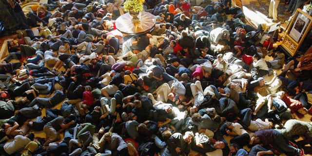 SAN FRANCISCO - AUGUST 20: Hundreds of people pretend to sleep as they participate in a "flash mob" in the lobby of the Westin St. Francis Hotel August 20, 2003 in San Francisco, California. Flash mobs are seemingly unplanned gatherings of people arrainged by email that converge in public places for brief periods of time, perform some brief action, and then disperse. (Photo by Justin Sullivan/Getty Images)