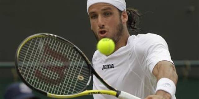 June 27, 2011:Spain's Feliciano Lopez returns a shot to Poland's Lukasz Kubot at the All England Lawn Tennis Championships at Wimbledon.