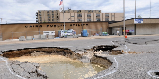 April 30: A sink hole from the Ohio River is seen on Commerce Avenue in Cairo, Ill. Mayor Judson Childs has issued a mandatory evacutation to residents.