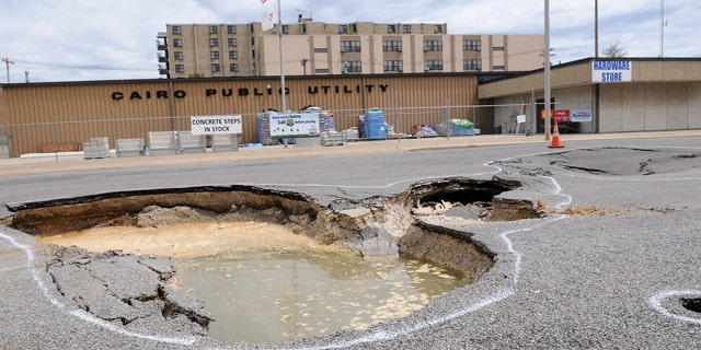 April 30: A sink hole from the Ohio River is seen on Commerce Avenue in Cairo, Ill. Mayor Judson Childs has issued a mandatory evacutation to residents.