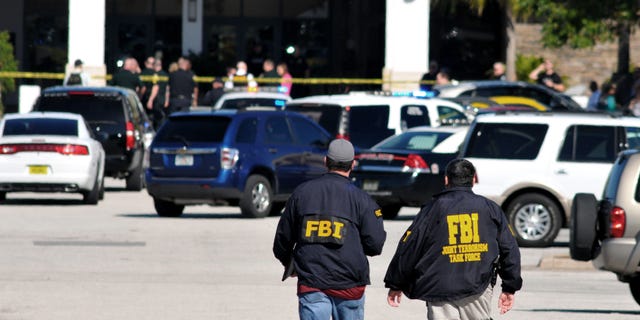Law enforcement including the FBI respond to the scene of a shooting at the Melbourne Square Mall on Saturday, Jan 17, 2015 in Melbourne, Fla. Melbourne Police have confirmed that the shooting Saturday morning at the mall has left two people dead and one injured from a gunshot wound. Police say the injured victim is hospitalized in stable condition and cooperating with investigators. After responding to reports around 9:30 a.m. of multiple shots fired inside the mall, police tweeted that the "shooter is contained." (AP Photo/Florida Today, Malcolm Denemark) NO SALES
