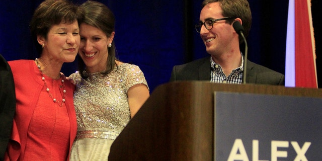 Alex Sink gets at a hug on stage from her daughter in St. Petersburg Tuesday evening March 11, 2014.