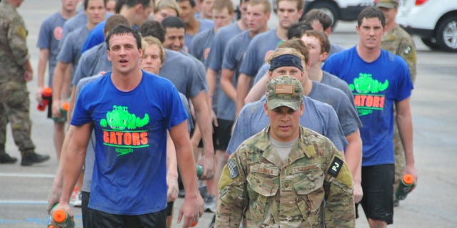 Jan. 4, 2012: Olympic gold medalists Ryan Lochte, front left, and Conor Dwyer, wearing a Gators t-shirt at far right, and members of the University of Florida swim team workout with members of the Guardian Angels of the 920th Rescue Wing at Patrick Air Force Base, Fla.