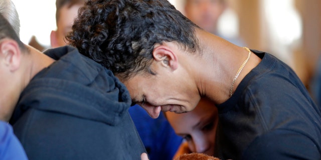 Stoneman Douglas High School students mourn the death of their classmates after a gunman opened fire and killed 17 people.
