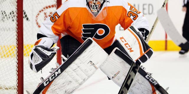 FILE - In this Jan. 18, 2014 file photo, Philadelphia Flyers' Steve Mason faces the action during the first period of an NHL hockey game against the New York Islanders, in Philadelphia. Mason practiced for only 15 minutes because of an upper-body injury and there's a chance the Flyers will start their playoff series against the Rangers without their No. 1 goalie. (AP Photo/Tom Mihalek, File)