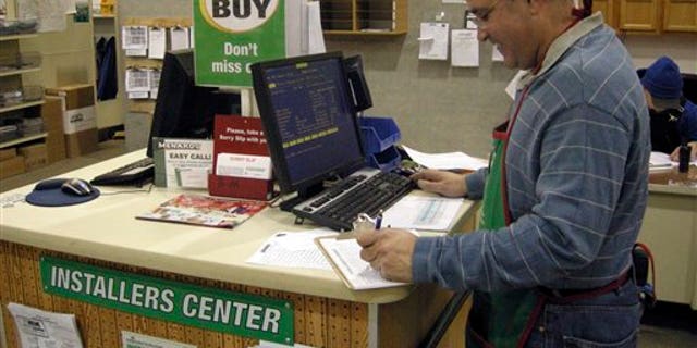Nov. 29, 2012: Juan Vadell works in the building materials section at the Menards in Minot, N.D.