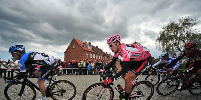 May 7, 2012: In this file photo, Taylor Phinney, second from left, of the United States, wears the overall leader's pink jersey as he rides through a corner during the third stage of the Giro d'Italia cycling race in Horsens, Denmark.
