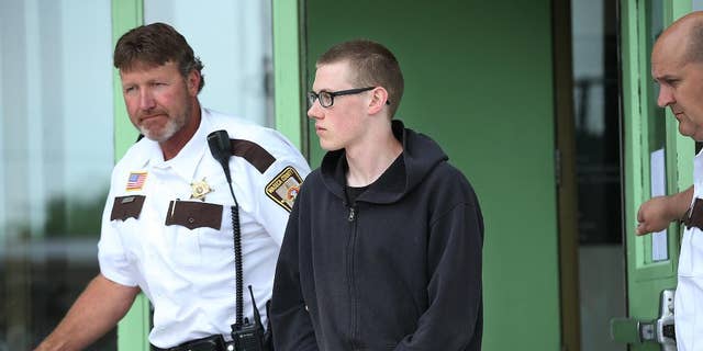 In this photo taken June 30, 2014, John LaDue, accused of planning an attack on his school, is escorted by Waseca County Sheriff's  Deputies for a hearing in Waseca, Minn. District Judge Robert Birnbaum on Friday, Aug. 21, 2015, has certified the Waseca teenager, accused of planning to kill his family and attack his high school, to stand trial as an adult. (Elizabeth Flores/Star Tribune via AP)  MANDATORY CREDIT; ST. PAUL PIONEER PRESS OUT; MAGS OUT; TWIN CITIES LOCAL TELEVISION OUT
