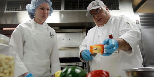 This Tuesday, Feb. 15, 2011 photo shows Megan Eckhardt, left, a student at the Culinary Institute of America, as she works with Anthony Fischetti, executive chef at Vassar Brothers Medical Center, in the kitchen of the hospital in Poughkeepsie, N.Y. The Culinary Institute of America, the well-known school for chefs north of New York City, is now offering a first-of-its-kind course on cooking for health care patients. Students in the elective class take field trips to nearby Vassar Brothers Medical Center and to Memorial Sloan-Kettering Cancer Center in Manhattan. (AP Photo/Mike Groll)