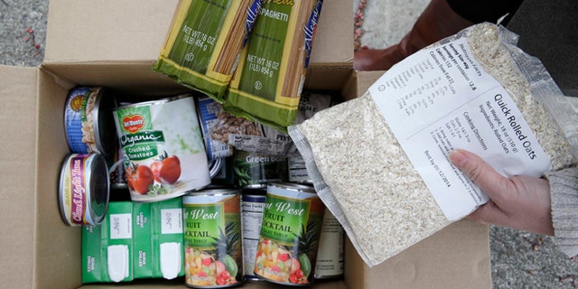 This photo taken Jan. 8, 2014 shows the contents of a specially prepared box of food at a food bank distribution in Petaluma, Calif., part of a research project with Feeding America to try to improve the health of diabetics in food-insecure families. Doctors are warning that the federal government could be socked with a bigger health bill if Congress cuts food stamps _ maybe not immediately, they say, but if the poor wind up in doctors' offices or hospitals as a result. (AP Photo/Eric Risberg)