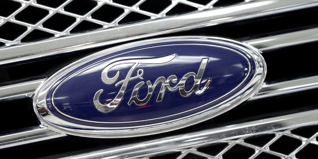 FILE - In this Jan. 5, 2015, file photo, the Ford logo shines on the front grille of a 2014 Ford F-150, on display at a local dealership in Hialeah, Fla. Ford will build a new $1.6 billion factory in Mexico, creating about 2,800 jobs and shifting small-car production from the U.S. The announcement Tuesday, April 5, 2016 comes at a time when moving jobs to the south has become a major issue in the U.S. presidential campaign. (AP Photo/Alan Diaz, File)