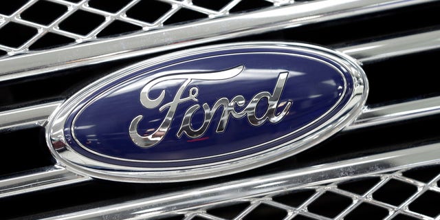 FILE - In this Jan. 5, 2015, file photo, the Ford logo shines on the front grille of a 2014 Ford F-150, on display at a local dealership in Hialeah, Fla. Ford will build a new $1.6 billion factory in Mexico, creating about 2,800 jobs and shifting small-car production from the U.S. The announcement Tuesday, April 5, 2016 comes at a time when moving jobs to the south has become a major issue in the U.S. presidential campaign. (AP Photo/Alan Diaz, File)