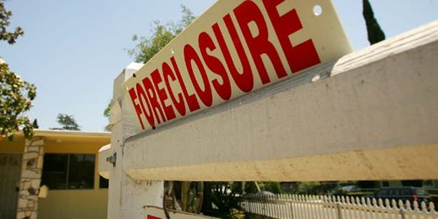 FILE - A foreclosure sign sits outside an Altadena, Calif. home.