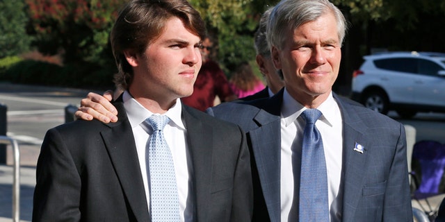 Former Virginia Gov. Bob McDonnell, right, arrives at federal court with his son Bobby, Tuesday, Sept. 2, 2014, in Richmond, Va.