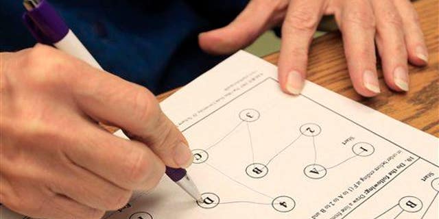Kathleen Sanford performs neurological cognitive tests on Dec. 17, 2012, in Columbus, Ohio.