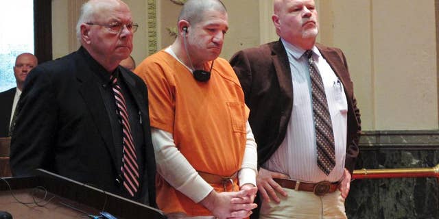 FILE - In this Jan. 14, 2015 file photo, Donald Hoffman, 41, stands between defense attorneys Robert Whitney, left, and Rolf Whitney as he pleads guilty to aggravated murder in a deal with prosecutors in Bucyrus, Ohio. Video of Hoffman's police interviews was released Friday, Feb. 13, 2015, and offers some explanation for the slayings, mostly a combination of drugs, money and anger. (AP Photo/Kantele Franko, File)
