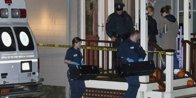 November 18, 2013: Workers from the Massachusetts medical examiner's office carry two small boxes to a home in a neighborhood of Arlington, Mass.