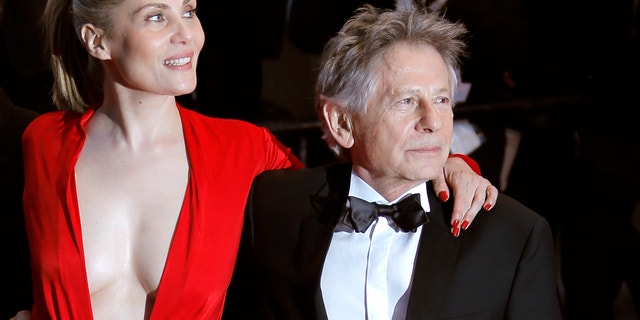 From left, actors Mathieu Amalric, Emmanuelle Seigner and director Roman Polanski leave following the screening of Venus In Fur at the 66th international film festival, in Cannes, southern France, Saturday, May 25, 2013. (AP Photo/Lionel Cironneau)