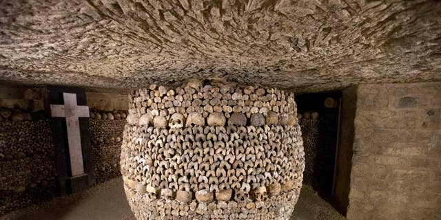 In this photo taken Tuesday, Oct. 14, 2014, skulls and bones are stacked at the Catacombs in Paris, France. The subterranean tunnels, stretching 2 kilometers (1.24 miles), cradle the bones of some 6 million Parisians from centuries past and once gave refuge to smugglers. The site used to close at 5 p.m., but is now staying open until 8 p.m. The change is mainly aimed at allowing more people to visit and reducing long lines, since it can only hold a limited number of people at a time and visits can’t be reserved in advance. (AP Photo/Francois Mori)