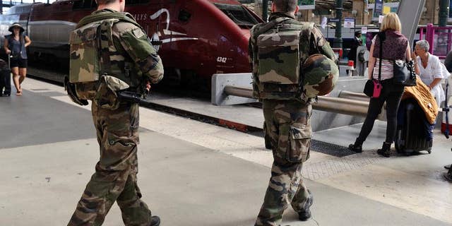 FILE - In this Aug .22 2015 file photo, French soldiers patrol at Gare du Nord train station in Paris, France. The attack Aug. 21 on the Thalys train from Amsterdam to Paris happened at the height of the summer travel season. France hosts emergency talks in Paris on Saturday, with representatives from other high-speed international rail nations, Belgium, Britain, Germany, Italy, Luxembourg, the Netherlands, Spain and Switzerland. (AP Photo/Binta, File)