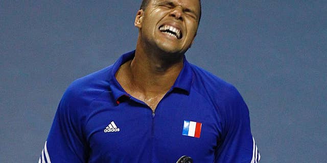 French tennis player Jo-Wifried Tsonga grimaces after missing a point during his single match against German player Peter Gojowczyk, in the quarterfinals of the Davis Cup in Nancy, eastern France, Friday April 4, 2014. France plays against Germany from Friday April 4 to Sunday April 6. (AP Photo/Remy de la Mauviniere)