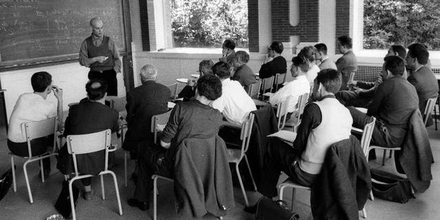 This photo provided Friday, Nov.14, 2014 by the IHES (High Scientific Studies Institute) shows mathematician Alexandre Grothendieck, at the blackboard, during a lesson, south of Paris, in the 1960's. Grothendieck, an opinionated and reclusive German-born giant of 20th-century mathematics who shunned accolades and supported pacifist and environmental causes, has died, the French presidency said Friday. He was 86. (AP Photo/IHES)