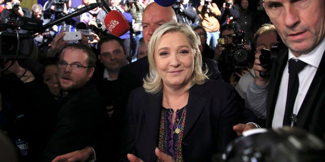 FILE - In this Dec.13, 2015 file photo, National Front party leader Marine Le Pen leaves after the results of the second round of the regional elections in Henin-Beaumont, northern France. (AP Photo/Thibault Camus, File)