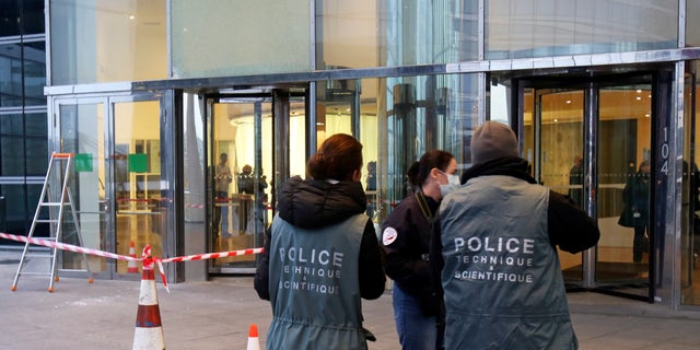 Nov. 18, 2013 - Police officers work at the entrance of the Societe General Bank headquarters in La Defense business district, west of Paris. Soon after a shooting at newspaper Liberation, shots were fired at the headquarters of a major French bank west of Paris, and a gunman briefly took a man hostage nearby. The Paris police headquarters said that it is not clear whether the three incidents are linked, but that authorities are increasing security in all three places as well as media offices around Paris.