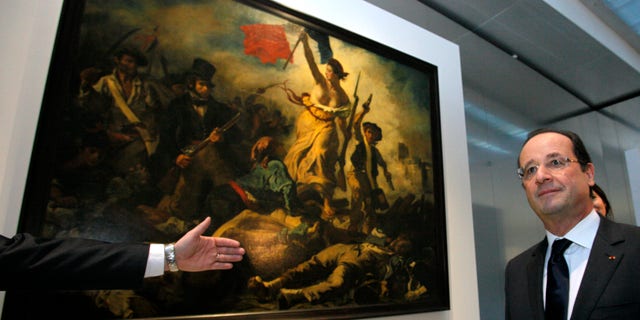 Dec. 4, 2012 - FILE photo shows French Pres. Francois Hollande in front of "Liberty Leading the People," a painting by Eugene Delacroix at the Louvre Museum in Lens, northern France.
