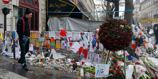 Dec. 8, 2015: A member of the band Eagles of Death Metal, Jesse Hughes, pays his respects to 89 victims who died in a Nov. 13 attack at the Bataclan concert hall in Paris. (AP Photo/Jacques Brinon)