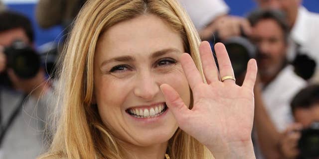 FILE - In this May 21, 2015 file photo, French actress and producer Julie Gayet poses for photographers during a photo call for the film Comoara (Treasure), at the 68th international film festival, Cannes, southern France. In her first appearance at an official ceremony in the presence of her partner President Francois Hollande, Gayet was invited Thursday June 18, 2015 to accompany her grandfather, Alain Gayet at a ceremony of commemoration of Charles de Gaulle’s Appeal of June 18 at the Mont Valerien memorial west of Paris (Photo by Joel Ryan/Invision/AP, File)