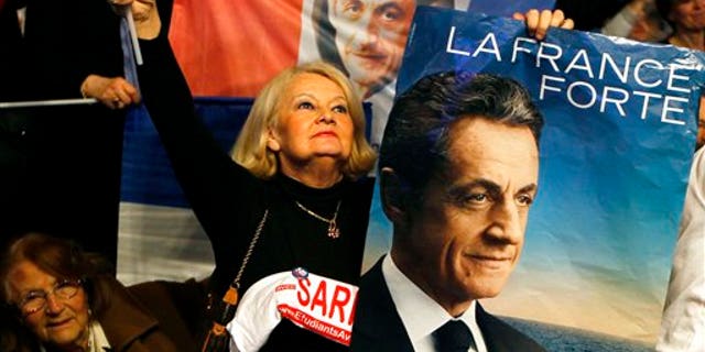 March 11: A supporter holds portrait of France's president and candidate for the upcoming re-election, Nicolas Sarkozy during a meeting in Villepinte, north of Paris, France, as part of his electoral campaign.