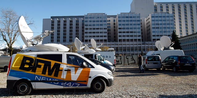 January 5, 2014: A TV van is parked in front of the Grenoble hospital where former seven-time Formula One champion Michael Schumacher is being treated after sustaining a head injury during a ski accident. (AP Photo/Claude Paris)