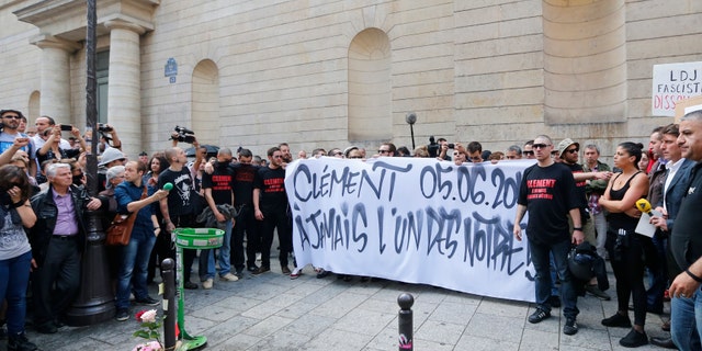 June 6, 2013: French far-left activists gather around flowers which lay at the foot of a concrete post where Clement Meric, 19, was attacked. A group of skinheads attacked a French far-left activist in the heart of Paris' shopping district, leaving the young man brain-dead in the hospital Thursday, officials said, in an attack that raised fears of increased far-right violence.