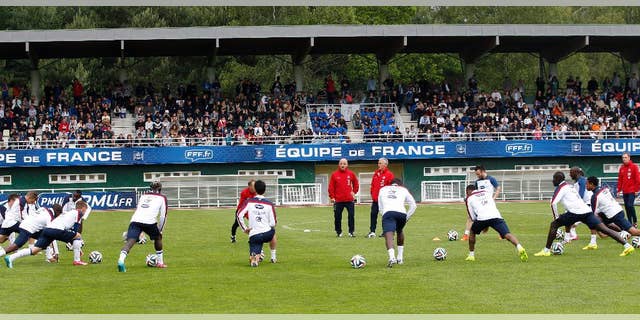 France's soccer players stretch, during a training session at the Clairefontaine training center, outside Paris, Thursday, May 29, 2014. France are preparing for the upcoming soccer World Cup in Brazil starting on 12 June. (AP Photo/Christophe Ena)