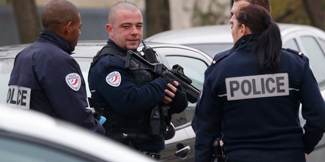Dec. 14, 2015: Police officers patrol near a preschool, after a masked assailant with a box-cutter and scissors who mentioned the Islamic State group attacked a teacher in the Paris suburb of Aubervilliers.