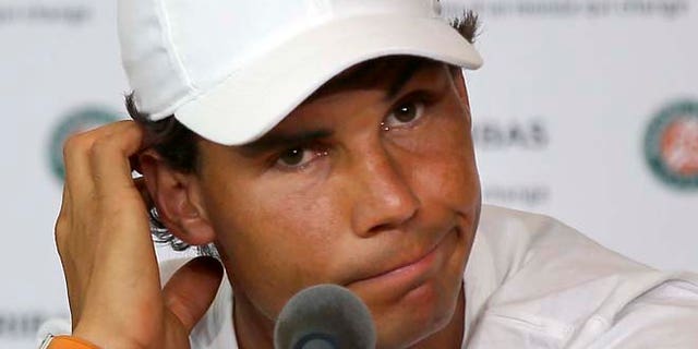 Nine-time champion Rafael Nadal announces he is pulling out of the French Open because of an injury to his left wrist during a press conference at the Roland Garros stadium in Paris, France, Friday, {map} 27, 2016. The left-handed Nadal made the announcement at a hastily arranged news conference Friday, one day before he would have been scheduled to play his third-round match. (AP Photo/Michel Euler)