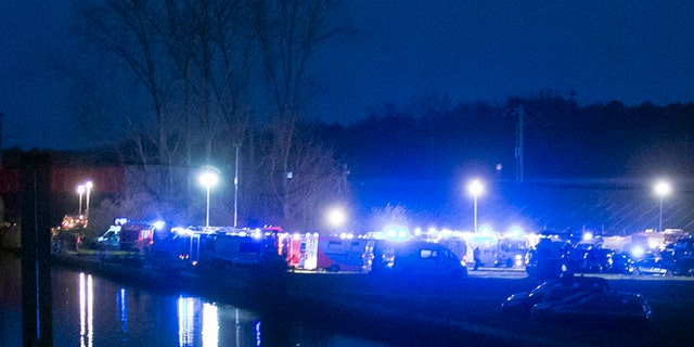 Rescue vehicles park between a canal and the railway tracks after a high-speed train derailed in Eckwersheim, near Strasbourg.