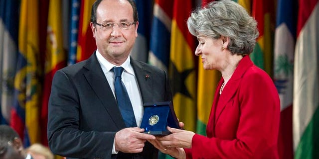 June 5, 2013: French President Francois Hollande receives the Felix Houphouet-Boigny Peace Prize from Director-General of UNESCO Irina Bokova, right, at the UNESCO headquarters in Paris, France.