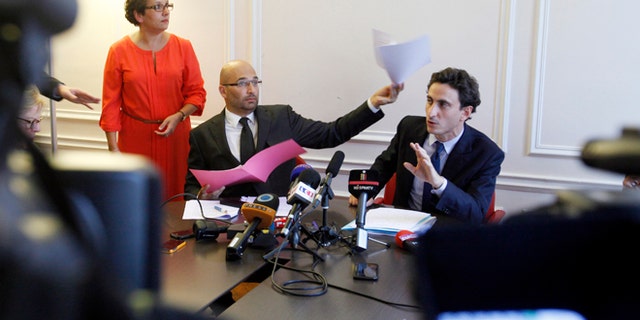 Oct. 2, 2013: Lawyers acting for the plaintiff, Slim ben Achour, left, and Felix de Belloy talk during a press conference in Paris.
