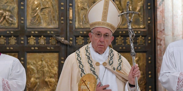 Pope Francis leaves after closing the Holy Door of St. Peter's Basilica at the Vatican, Sunday, Nov. 20, 2016. Pope Francis has pulled shut the Holy Door of St. Peter's Basilica, formally ending the Holy Year of Mercy he declared to highlight that virtue. (Tiziana Fabi/pool photo via AP)