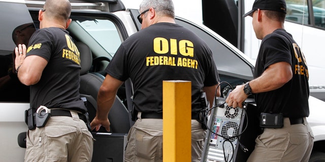 FILE - In this May 2, 2012, file photo, Federal agents with the Office of Inspector General load computers seized from Willsand Home Health Agency, Inc. into a van in Miami. Over the past decade, South Florida has become less renowned for "old school" drug shootouts than for scammers stealing hundreds of millions of dollars from the government, banks and individuals. South Florida has become the nation's organized fraud capital. (AP Photo/Alan Diaz, File)