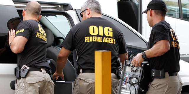 FILE - In this May 2, 2012, file photo, Federal agents with the Office of Inspector General load computers seized from Willsand Home Health Agency, Inc. into a van in Miami. Over the past decade, South Florida has become less renowned for "old school" drug shootouts than for scammers stealing hundreds of millions of dollars from the government, banks and individuals. South Florida has become the nation's organized fraud capital. (AP Photo/Alan Diaz, File)