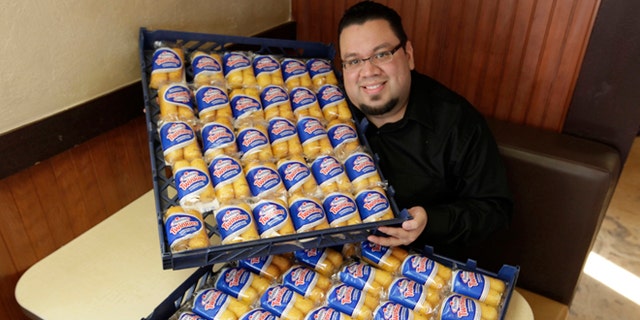 Dec. 5, 2012: Andres DeLeon of Baby's Steak &amp; Lemonade in Orland Park, Ill, poses with a large supply of Hostess Twinkies at his restaurant.