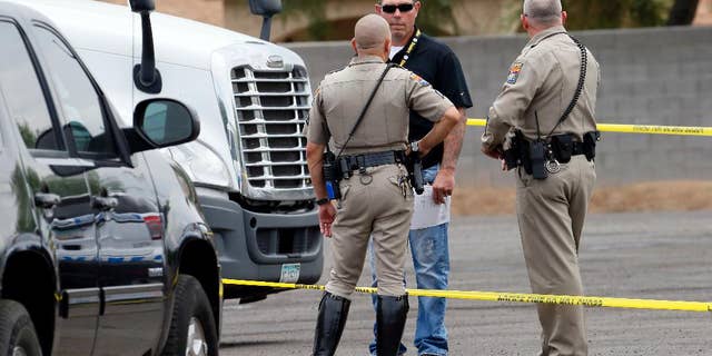 A sign displaying the shooter tip line sits above the cars on the Interstate 10 and 7th Streets, Thursday, Sept. 10, 2015 in Phoenix. The search for a suspect in a string of Phoenix freeway shootings took on a frenzied pace Thursday, with a panicked public flooding a police hotline with tips. Police confirmed one of these reports as a shooting, raising to 11 the number of vehicles struck on Phoenix-area freeways since Aug. 29. (Patrick Breen/The Arizona Republic via AP) MARICOPA COUNTY OUT; MAGS OUT; NO SALES; MANDATORY CREDIT