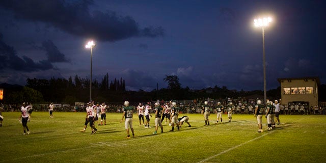 Oct. 16, 2010: Stadium lights shine down on a high school football game in Kapaa, Hawaii on the island of Kauai. Kauai high school football games, traditionally held on Friday nights, are now being played on Saturday afternoon due to a need to protect a threatened seabird which becomes disoriented during flight because of the bright stadium lights. The change has unsettled the community.