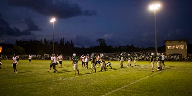 Oct. 16, 2010: Stadium lights shine down on a high school football game in Kapaa, Hawaii on the island of Kauai. Kauai high school football games, traditionally held on Friday nights, are now being played on Saturday afternoon due to a need to protect a threatened seabird which becomes disoriented during flight because of the bright stadium lights. The change has unsettled the community.